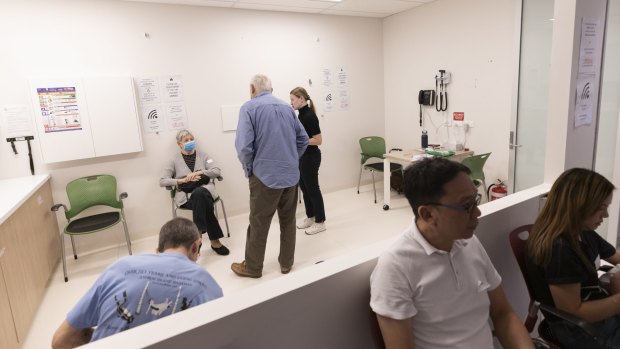 Patients sit in a waiting area after receiving the COVID-19 AstraZeneca vaccine at the Sydney West COVID vaccination centre in Olympic Park on April 6.