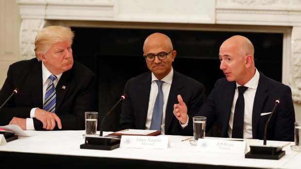 Butting heads: Donald Trump with Microsoft CEO Satya Nadella and Amazon boss Jeff Bezos.