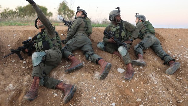 Israeli soldiers take cover near the Israel-Gaza border following a barrage of mortar and rocket fire that wounded six people in November. 