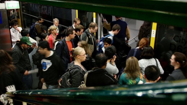 Commuters crowd to board a train at Town Hall.