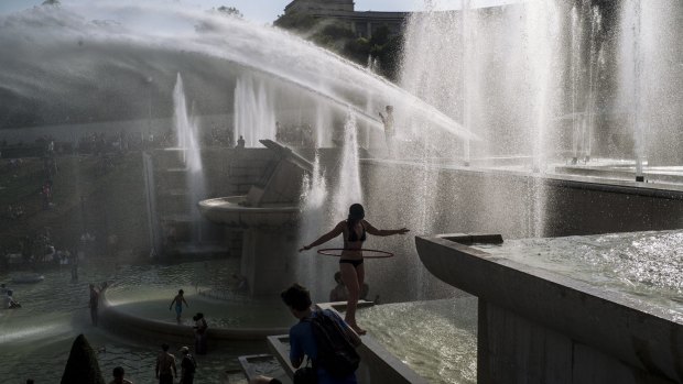 People cool down in the fountains of the Trocadero gardens in Paris on July 25 last year, when the temperature hit 42.6 degrees, a record for the French capital. 