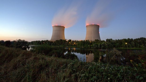 Vapor rises from cooling towers at the Saint-Laurent-des-Eaux nuclear power plant in France.