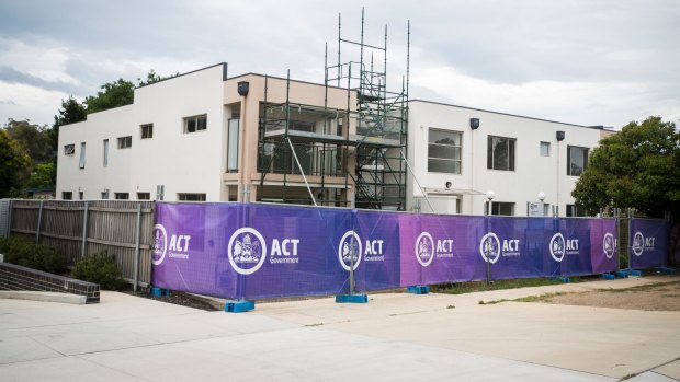 The Braddon public housing has sat empty for three years because of a dispute between the government and builder. 