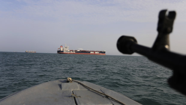 A speedboat of Iran's Revolutionary Guard trains a weapon toward the British-flagged oil tanker Stena Impero, which was seized in the Strait of Hormuz on July 19 by the Guard.