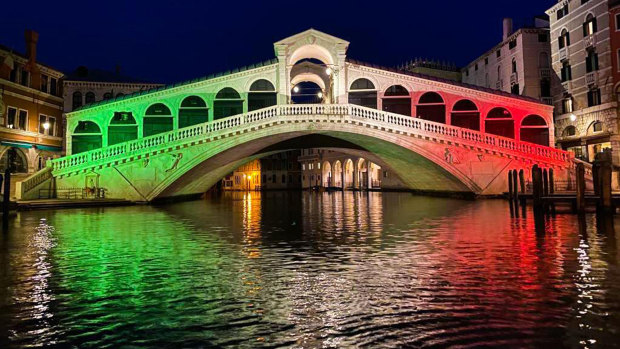 The Rialto Bridge in Venice is lit up in the colours of the Italian flag in honour of the medical workers on the COVID-19 frontlines. The city's economy has been hit hard by the pandemic.