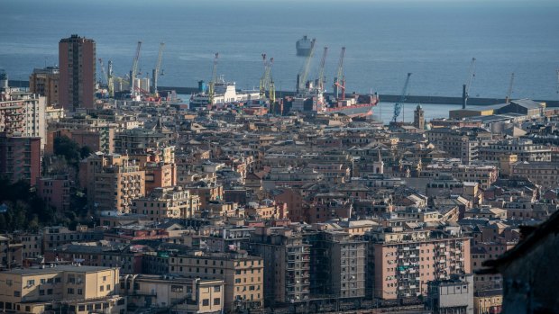 Container ships sit in the port at Genoa, Italy.