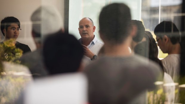 Director of Icon NSW Julian Doyle (centre) tells residents they need to evacuate the apartment building for a second time due to safety concerns on Thursday.