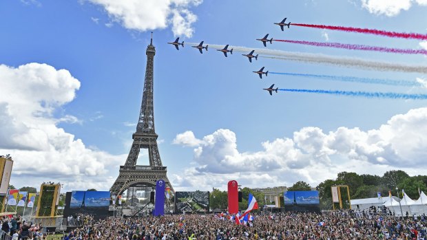 French Elite acrobatic team Patrouille de France flyes over the Eiffel Tower during the Olympic Games handover from Tokyo to Paris in 2021.