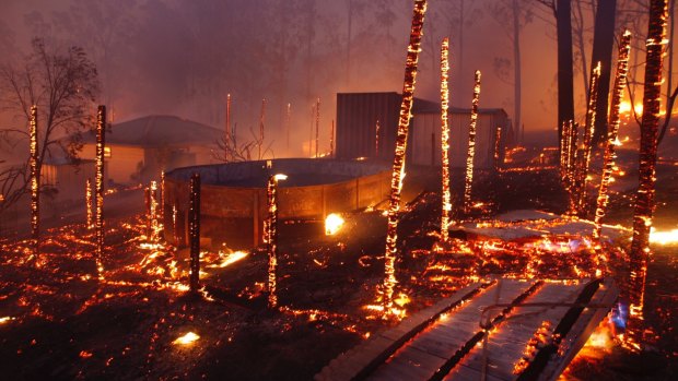 Burning properties in Rainbow Flat after fire from the Hillville Fire broke containment lines and crossed the Pacific Highway.