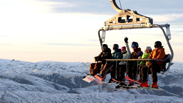 Re-opening for business:  skiers and snowboarders ride chairlifts in Cardrona, New Zealand.  