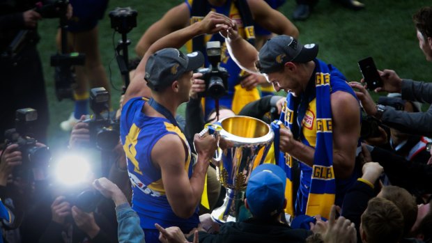 West Coast players celebrate the club's fourth premiership.