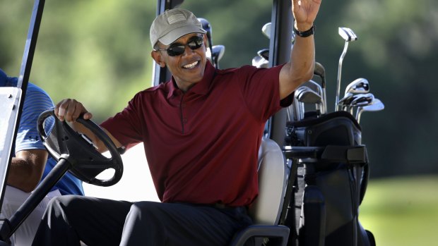 Trump criticised Obama for his frequent golfing. President Barack Obama waves from a golf cart in 2015. 