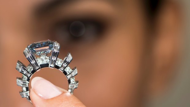 A model displays the “Sky Blue Diamond”, a fancy vivid blue 8.01 carat jewel of imperial Russian heritage in Geneva, Switzerland.