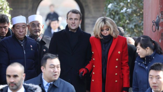 French President Emmanuel Macron, centre, and his wife Brigitte Macron, in red, visit the Great Mosque of Xian during a visit to the Great Mosque of Xian in northwestern China in 2018.