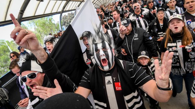 Collingwood fans in full voice make their way to the MCG.