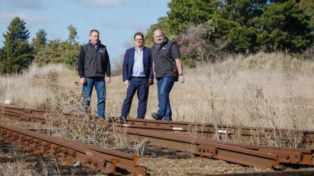 Director of Capital Recycling Solutions Adam Perry, Dean Ward from ActewAGL, and project manager Ewen McKenzie at the former Shell site, which planned to use the railway to export recyclables.