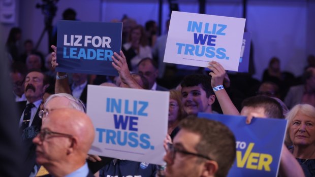 Members of the Conservative Party hold signs supporting Liz Truss for PM, during a leadership hustings in Norwich on August 25.