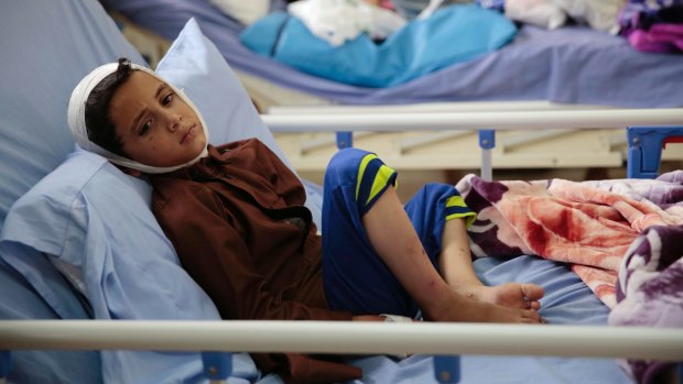 A child injured in a deadly Saudi-led coalition airstrike on on a school bus rests in a hospital in Saada, Yemen.