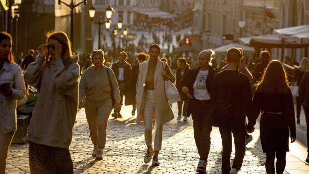 Muscovites stroll on a warm evening - most of them without face masks last month.