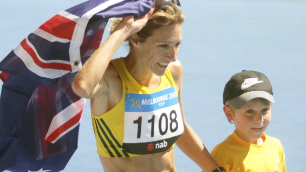 Australia's Kerryn McCann celebrates her marathon victory with son Benton.