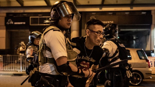 A protester is detained by police outside of Po Lam Station in Hong Kong on September 5.
