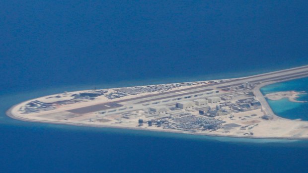 An airstrip, structures, and buildings on China's man-made Subi Reef in the Spratly chain of islands in the South China Sea are seen from a Philippine Air Force C-130 transport plane of the Philippine Air Force. 