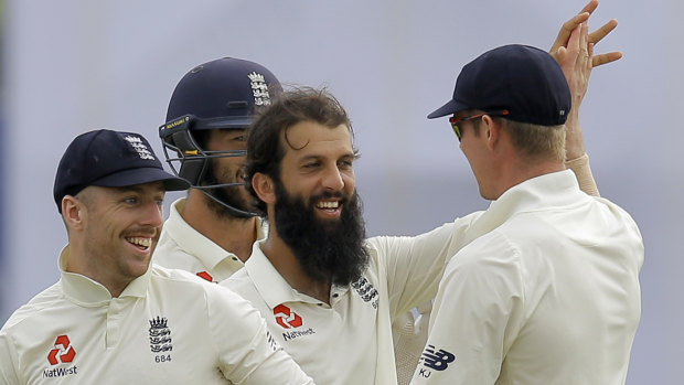 Dominant: England's Moeen Ali celebrates the dismissal of Sri Lanka's Niroshan Dickwella.
