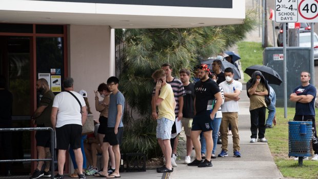 Job hunters queue up outside a Centrelink office.