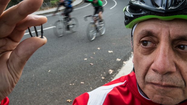 George Mihailides pictured back in 2015 with tacks found on Yarra Boulevard. 