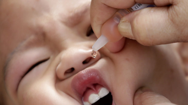 A local health worker administers the vaccine to a baby at a local health centre in Manila.