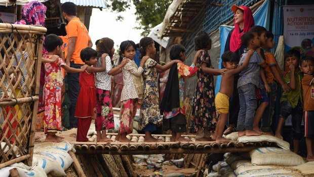 Rohingya children queue for vaccinations at a UNICEF nutrition centre in a refugee camp.