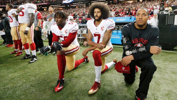 Colin Kaepernick (centre) has been knocked back by the Seahawks.