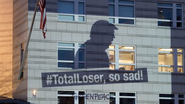 A Greenpeace image showing the shadow of US President Donald Trump, who pulled the US out of the Paris Agreement, is projected onto the facade of the US embassy in Berlin last June. 