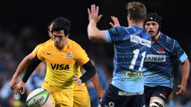 Cheeky: Matias Moroni of the Jaguares chips the ball over Cameron Clark before scoring.