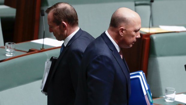 Liberal MPs Tony Abbott and Peter Dutton depart after Question Time at Parliament House on August 21.