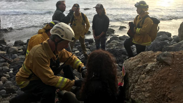 Authorities tend to Angela Hernandez after she was rescued, in Morro Bay, California. 
