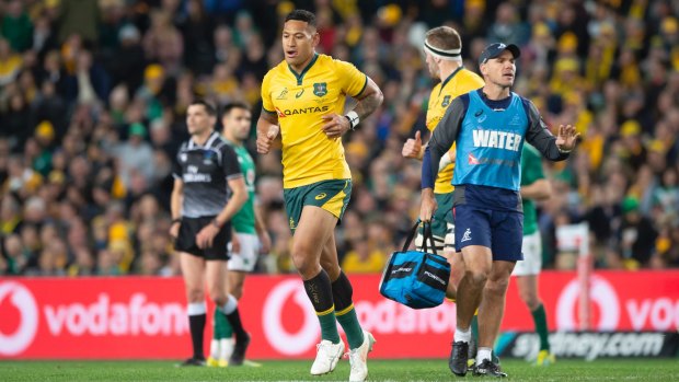 Contentious: Folau leaves the field after being yellow carded for contact in the air. 