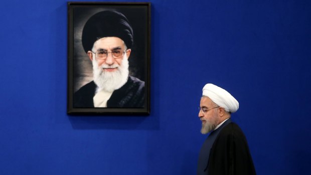 Iranian President Hassan Rouhani was elected after economic unrest in 2013 unnerved Supreme Leader Ali Khamenei (in the portrait). 