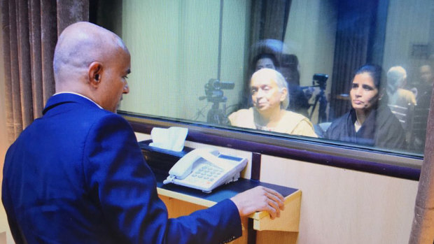 Jailed Indian naval officer Kulbhushan Jadhav, left, meets with his mother (centre) and wife in an Islamabad prison in 2017.