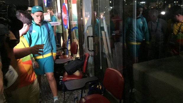 Archer Alec Potts walks to the judge's chambers after hours of questioning by police at the Rio Olympics.