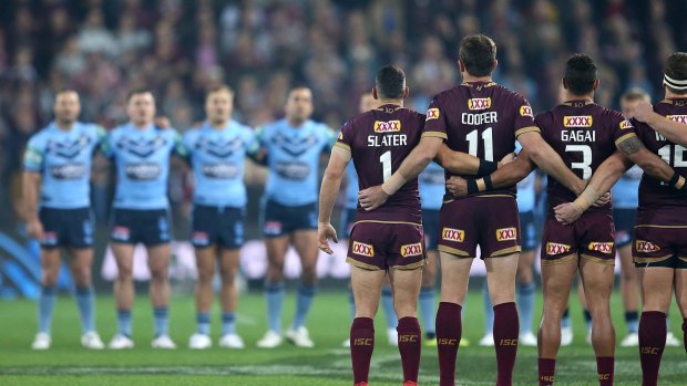 All together now?: NSW and Queensland players sing the national anthem before game three last year. 