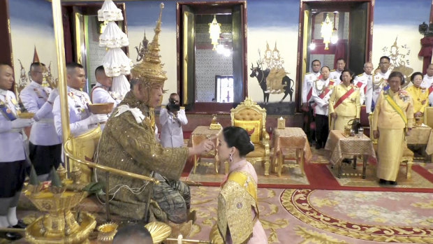 The king's wife, Queen Suthida, participates in a ritual at the Grand Palace in Bangkok during his coronation.
