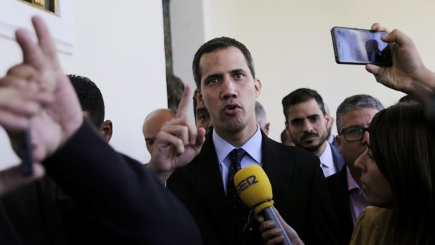 Opposition National Assembly President Juan Guaido, centre,  has declared himself interim president of Venezuela.