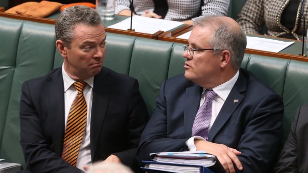 Christopher Pyne and Scott Morrison listen to prime minister Tony Abbott during question time in June 2015.
