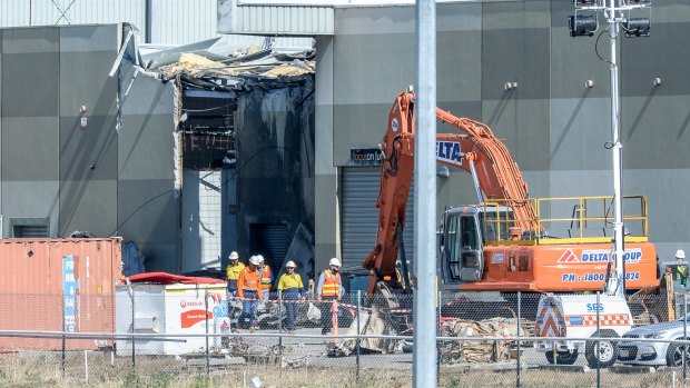 Workers at the scene in 2017 of the plane crash at the DFO shopping centre in Essendon.