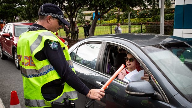 Police check cars for permits at a checkpoint in Coolangatta as the Queensland border re-opened to most other states on July 10.