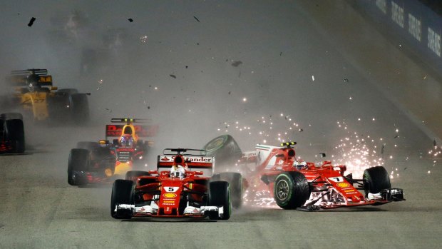 Sparks fly: Ferrari driver Kimi Raikkonen, right, collides with teammate Sebastian Vettel of Germany at the start of the 2017 Singapore Grand Prix on the Marina Bay City Circuit.