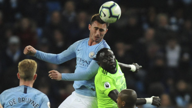 Manchester City's Aymeric Laporte heads the ball.