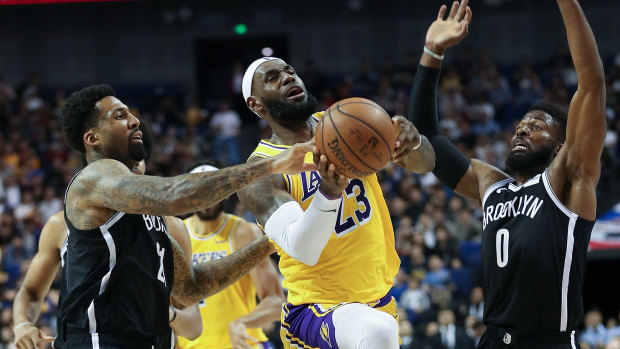 Lakers superstar LeBron James drives to the basket against the Nets.