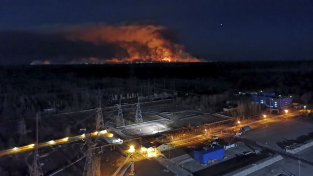 A forest fire is seen burning inside the exclusion zone around Ukraine's Chernobyl nuclear power plant, foreground, last week.